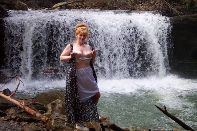 Playing With Nipples By A Waterfall , Playing With Nipples By A Waterfall, White Petticoat, Front Of Dress Unbuttoned, Bra Pulled Down And Playing With Nipples
