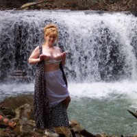 Playing With Nipples By A Waterfall , Playing With Nipples By A Waterfall, White Petticoat, Front Of Dress Unbuttoned, Bra Pulled Down And Playing With Nipples