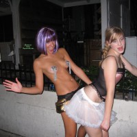 Two-girl Fantasy Strip Tease - Blonde Hair , Mistress And Slave Play, Lip Licking, Tongue Out, Drunken Public Dare, Standing Facing Camera, Flirty Skirt, Purple Party Wig, Silver Tassled Pasties, Blonde About To Get Her Butt Slapped, Smack That Ass, Hand Slapping Butt