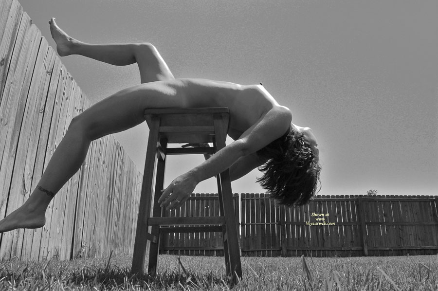 Arched Nude Woman On A Stool - Naked Girl , Lying Back On A Wooden Stool Out In The Yard, Black And White Nude Photo, Tattooed Ankle