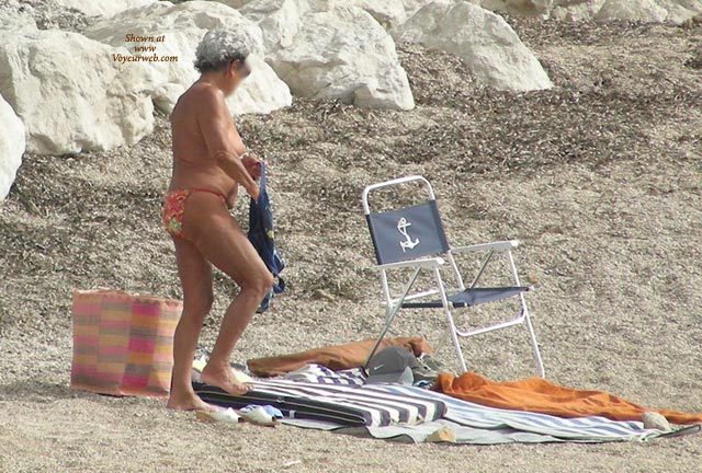 Pic #1Old Woman Changing On The Beach
