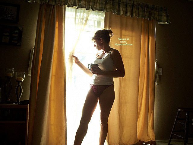 Morning Coffee In Hand , Toned Legs, Drinking Coffee, Athletic Build, Housewife Window, Toned Body, Purple Panties, White Tank Top, Sunlight Reflection, Coffe Break Against The Light, Peek-a-boo, Morning Sun Kissing Panties, Standing In Window