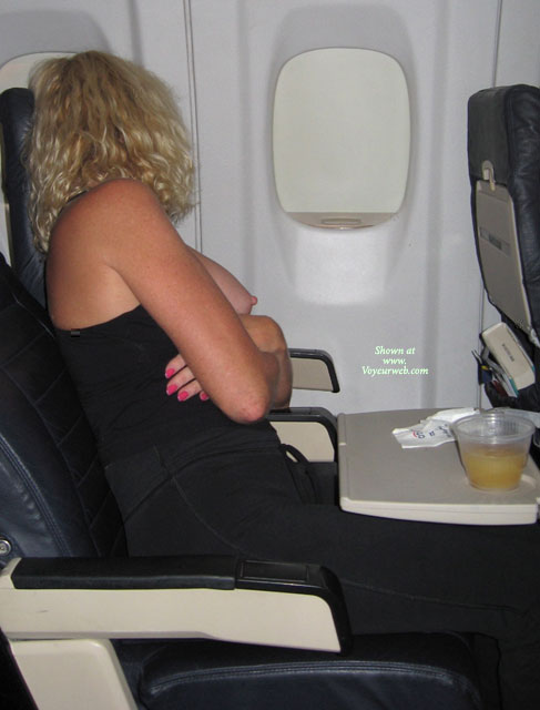 Naughty Blond With Curls Exposing Tits On An Airplane - Blonde Hair , Sitting On An Airplane, Seated On Airplane, Boob Flash On Airplane, Arms Crossed, Exposed Breast, Mile High Boob, Single Breast Out, Exposed On Airplane