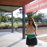 Lowering Her Top In Public - Exhibitionist, Flashing, Long Hair, Milf, Nude In Public, Sunglasses, Topless, Naked Girl, Nude Amateur , Top Down, Flashing Pic, Topless Nude, Public Milf, Green And White Top, Wide City Scene In Background, Brown Belted Denim Skirt, Nice Tits, Smiling Directly At The Camera, Morning Flash