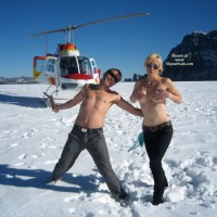 Topless Man And Woman With Helicopter - Blonde Hair, Sunglasses, Topless , Standing Topless In Snow With Helicopter In Backgound, Topless Only, Hot In Cold Snow, Topless Blonde With Chopper, Couple With Helicopter, Sun Glasses, Black Jeans, Covering Tits In The Snow, Topless In The Snow